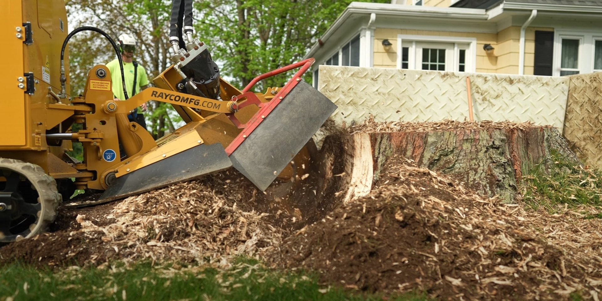 Stump grinding services preparing yard for new landscaping projects Professional stump grinding equipment removing tree stump for landscaping preparation